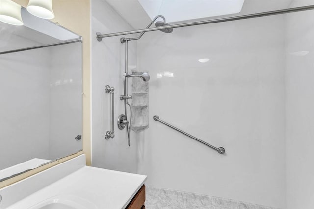 bathroom featuring vanity and a shower