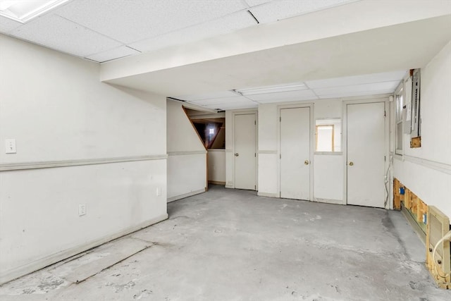 basement featuring a paneled ceiling