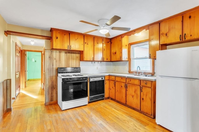 kitchen with white appliances, backsplash, sink, light hardwood / wood-style flooring, and ceiling fan