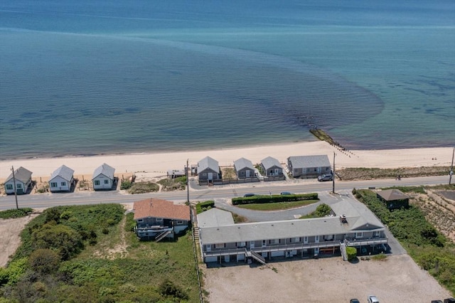 drone / aerial view with a water view and a beach view