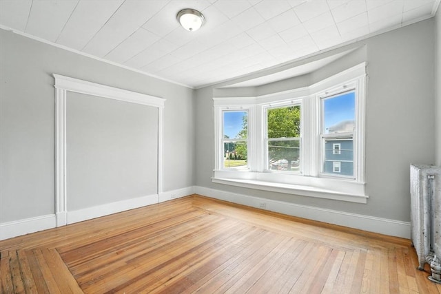 782 Sumner Ave, Springfield, MA 01108 - spare room featuring ornamental molding, radiator heating unit, and wood-type flooring