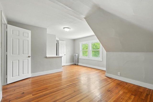 782 Sumner Ave, Springfield, MA 01108 - additional living space with radiator heating unit, hardwood / wood-style flooring, and vaulted ceiling