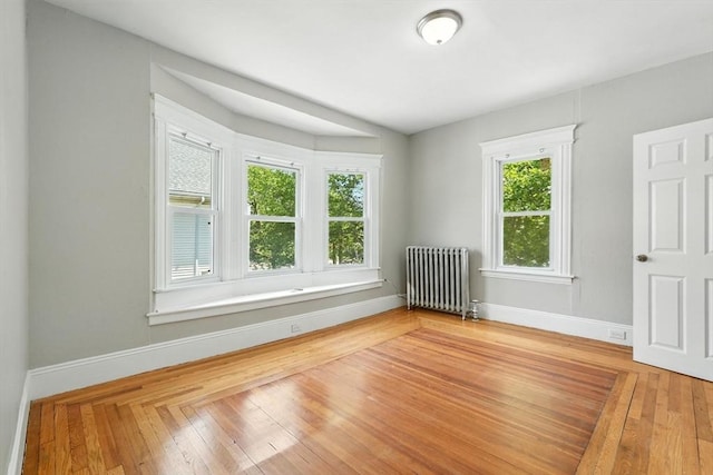 782 Sumner Ave, Springfield, MA 01108 - empty room featuring radiator and light wood-style floors