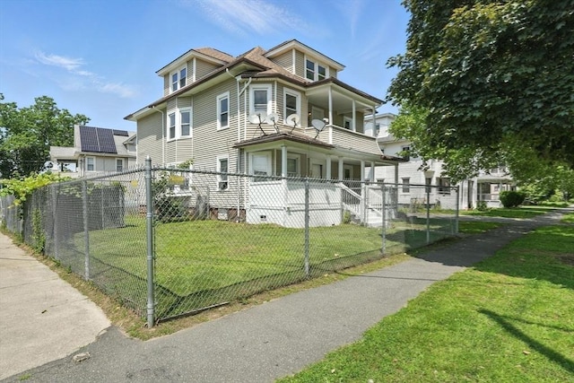 782 Sumner Ave, Springfield, MA 01108 - view of side of property with a fenced front yard, a balcony, and a porch