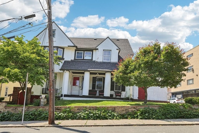 24 Central St, Somerville, MA 02143 - view of front facade with stucco siding, a shingled roof, and covered porch