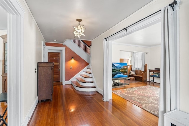 24 Central St, Somerville, MA 02143 - foyer with hardwood / wood-style floors, baseboards, crown molding, stairway, and a chandelier