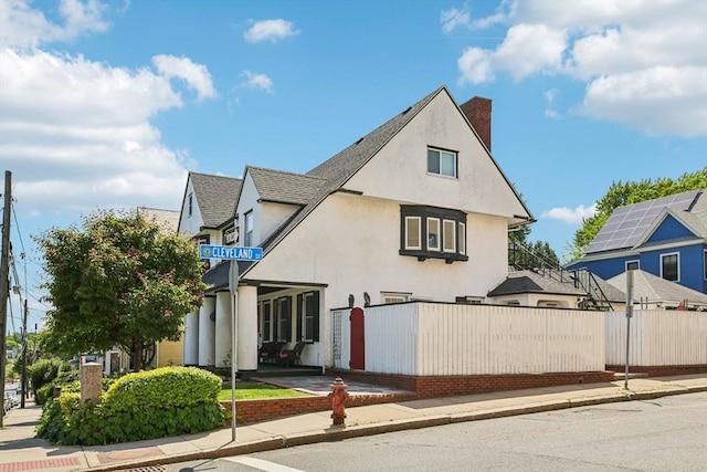 24 Central St, Somerville, MA 02143 - view of front facade featuring stucco siding and a chimney