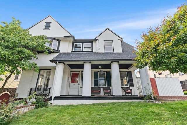 24 Central St, Somerville, MA 02143 - view of front facade with stucco siding, roof with shingles, a front yard, and covered porch