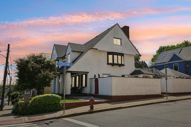 24 Central St, Somerville, MA 02143 - view of front facade with stucco siding and a chimney