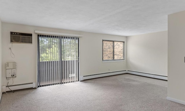 9 Davis Rd Unit C10, Acton, MA 01720 - unfurnished room with baseboard heating, a wall mounted air conditioner, and carpet flooring