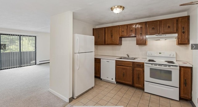 9 Davis Rd Unit C10, Acton, MA 01720 - kitchen with white appliances, under cabinet range hood, a baseboard radiator, light countertops, and backsplash