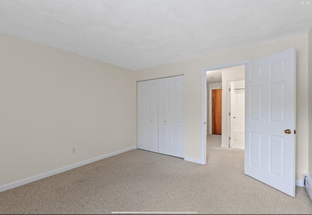 9 Davis Rd Unit C10, Acton, MA 01720 - unfurnished bedroom featuring light carpet, a closet, and a baseboard radiator