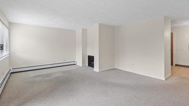 9 Davis Rd Unit C10, Acton, MA 01720 - unfurnished living room featuring carpet floors, a baseboard radiator, and a fireplace