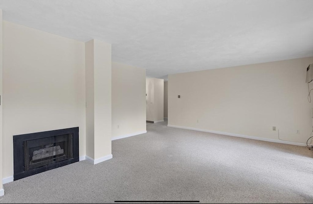 9 Davis Rd Unit C10, Acton, MA 01720 - unfurnished living room featuring carpet and a fireplace