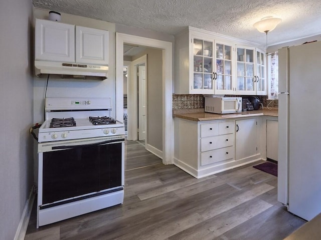 kitchen featuring pendant lighting, white appliances, dark wood-type flooring, and white cabinets