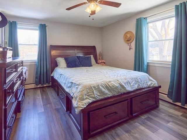 bedroom with a baseboard radiator, ceiling fan, and light wood-type flooring