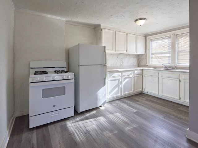 kitchen featuring sink, a textured ceiling, light hardwood / wood-style flooring, white appliances, and white cabinets