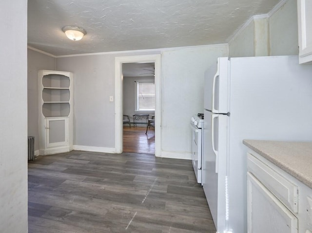 kitchen featuring white cabinetry, crown molding, radiator heating unit, dark hardwood / wood-style flooring, and white appliances