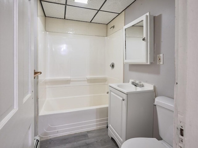 full bathroom featuring toilet, bathing tub / shower combination, a paneled ceiling, vanity, and hardwood / wood-style floors