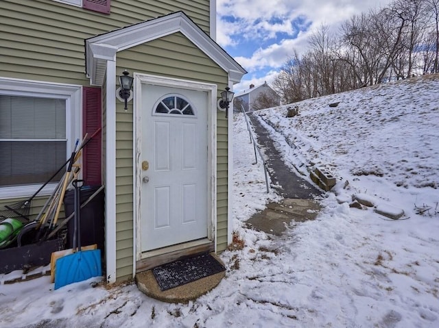 view of snow covered property entrance