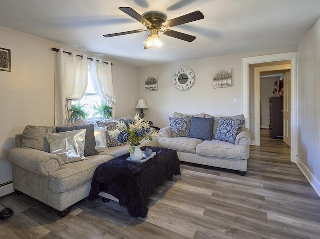 living room featuring hardwood / wood-style floors and ceiling fan