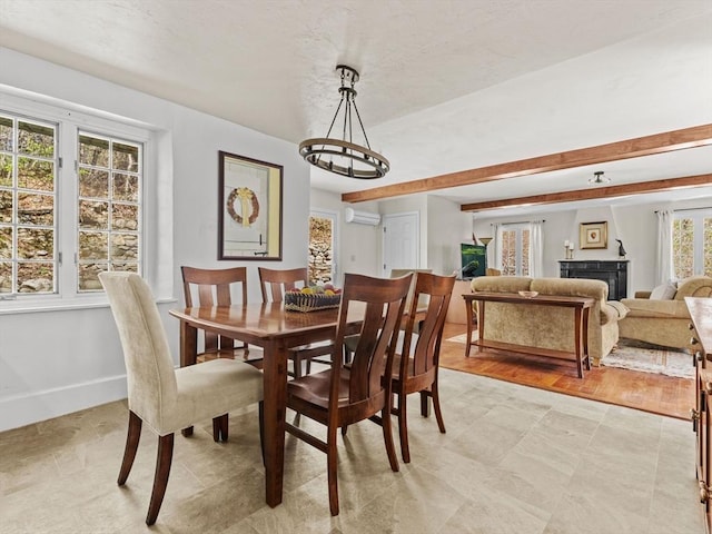 dining space featuring baseboards, a wall unit AC, and a fireplace