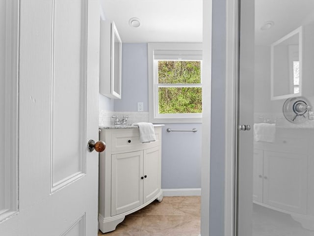 bathroom with vanity and baseboards