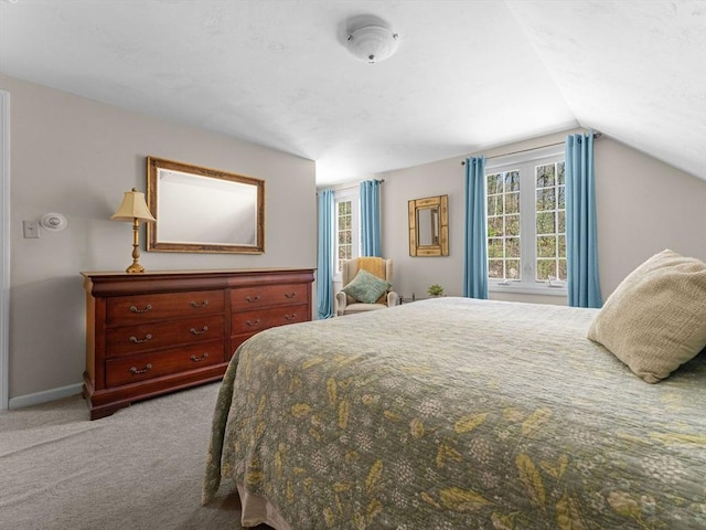bedroom featuring carpet floors, baseboards, and lofted ceiling