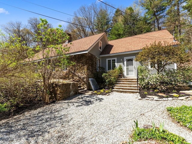 single story home with roof with shingles