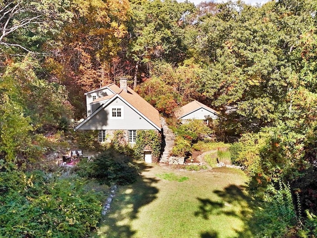 birds eye view of property with a forest view