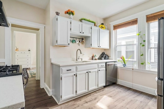 11 Sedgwick St Unit 8, Boston, MA 02130 - kitchen featuring stainless steel appliances, light wood-style flooring, light countertops, and white cabinets