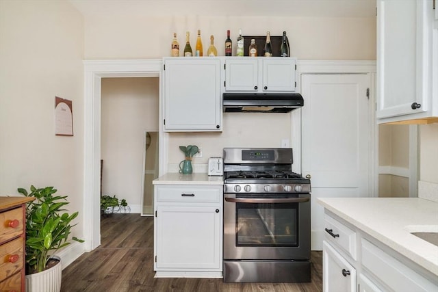 11 Sedgwick St Unit 8, Boston, MA 02130 - kitchen with under cabinet range hood, gas range, light countertops, and white cabinetry