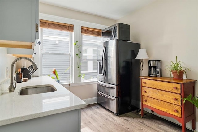 11 Sedgwick St Unit 8, Boston, MA 02130 - kitchen featuring stainless steel appliances, plenty of natural light, light wood-style flooring, and light stone countertops