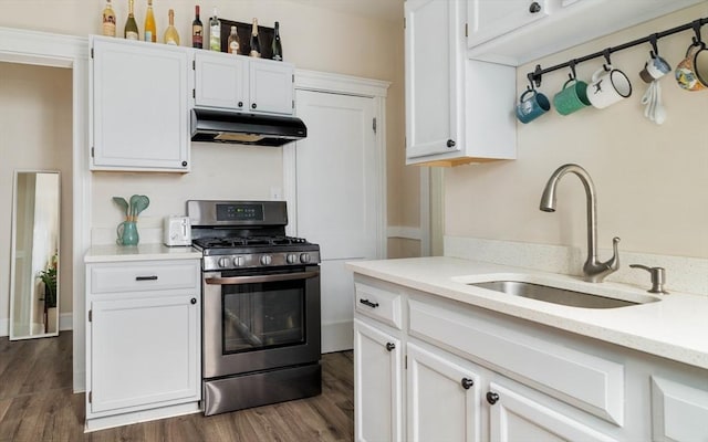 11 Sedgwick St Unit 8, Boston, MA 02130 - kitchen featuring stainless steel gas range oven, under cabinet range hood, dark wood-style flooring, and white cabinetry