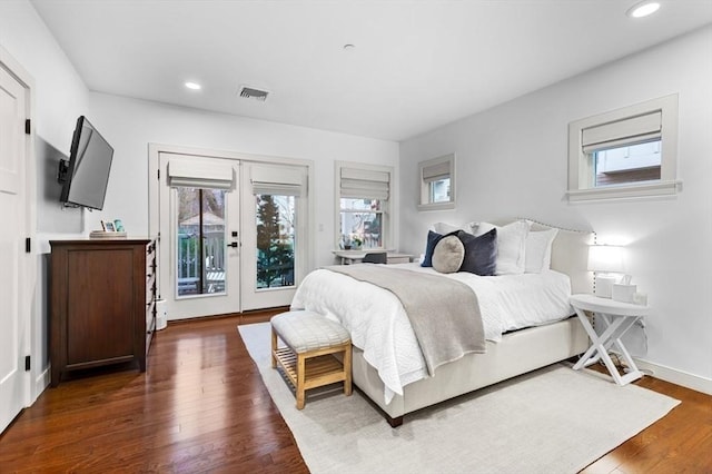 bedroom with access to exterior, french doors, and dark hardwood / wood-style flooring