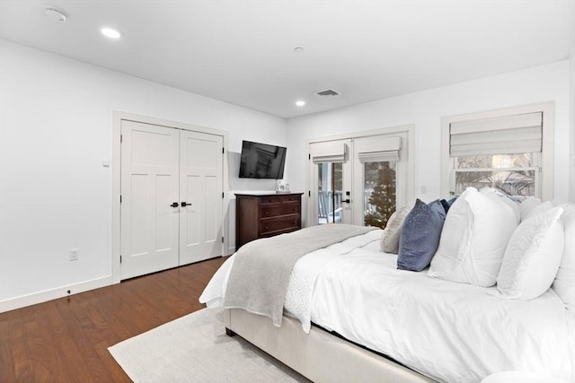 bedroom with access to exterior, dark hardwood / wood-style flooring, and french doors