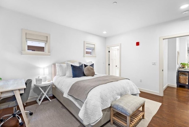 bedroom with dark hardwood / wood-style flooring