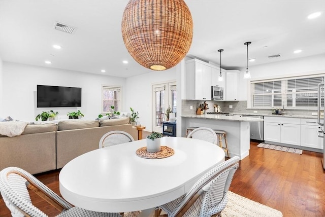 dining space featuring sink and dark wood-type flooring