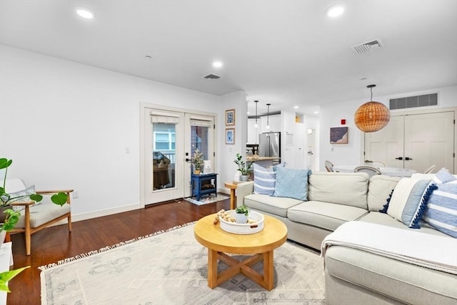 living room with hardwood / wood-style floors and french doors