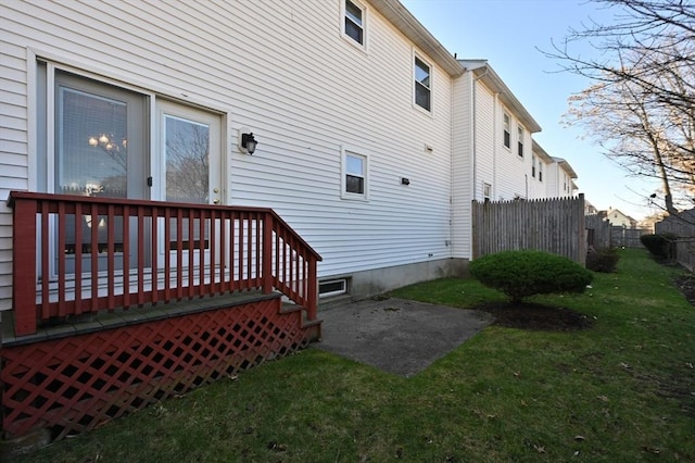 view of side of property featuring a wooden deck and a yard