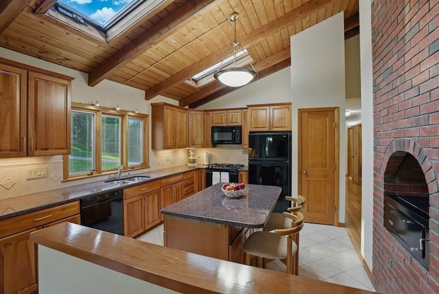 34 Marlboro St, Hudson, MA 01749 - kitchen with black appliances, a skylight, a sink, a kitchen island, and a warming drawer