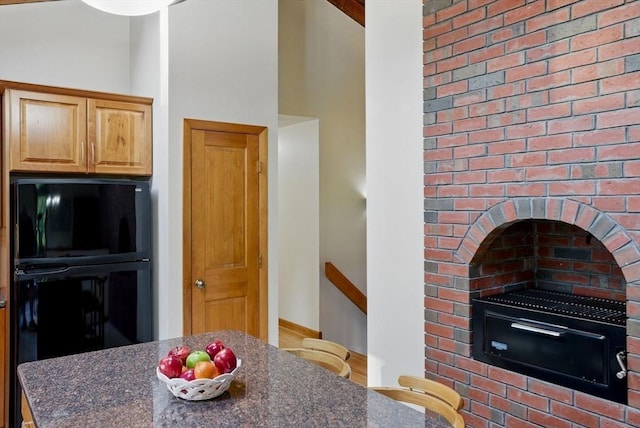 34 Marlboro St, Hudson, MA 01749 - kitchen with dark stone counters, freestanding refrigerator, and baseboards