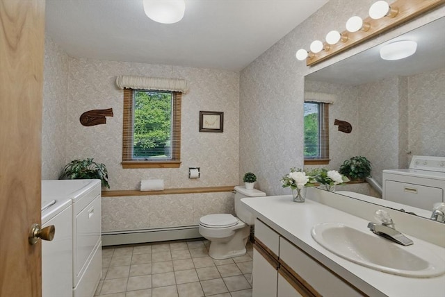 34 Marlboro St, Hudson, MA 01749 - full bath with a baseboard radiator, washer and dryer, vanity, toilet, and tile patterned flooring