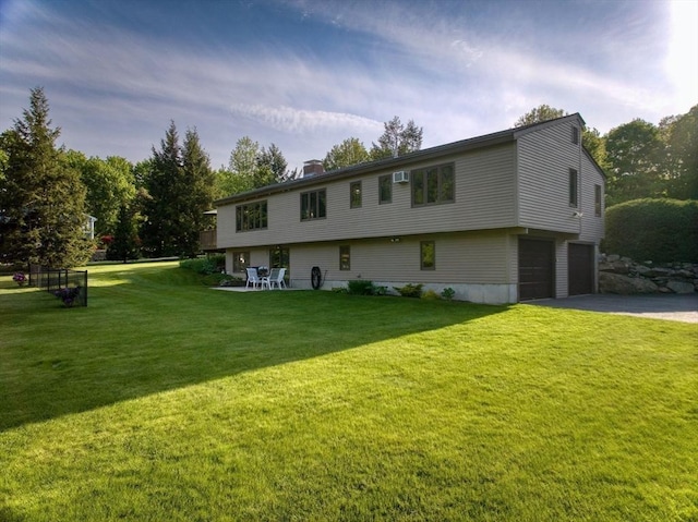 34 Marlboro St, Hudson, MA 01749 - view of front facade featuring a garage, asphalt driveway, a front yard, and a chimney