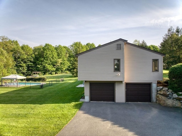 34 Marlboro St, Hudson, MA 01749 - view of side of home with driveway, a lawn, a garage, and an outdoor pool