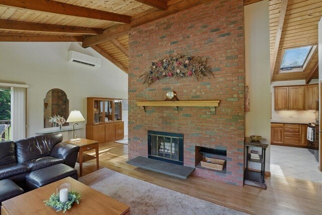 34 Marlboro St, Hudson, MA 01749 - living area with a wall mounted air conditioner, light wood-style flooring, beam ceiling, wood ceiling, and a fireplace