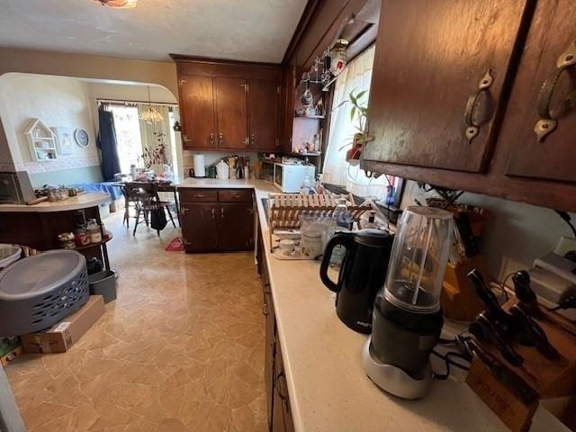 59 Eddy St, Springfield, MA 01104 - kitchen featuring light countertops, dark brown cabinets, and open shelves