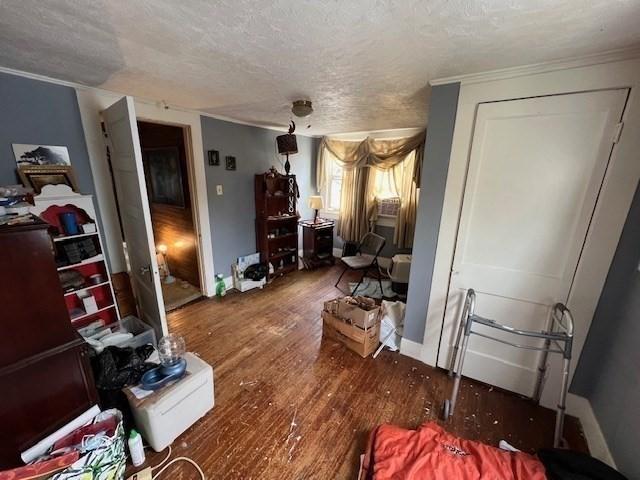 59 Eddy St, Springfield, MA 01104 - bedroom featuring a textured ceiling, wood finished floors, and crown molding