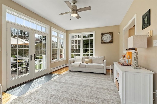 sunroom / solarium featuring baseboards, a baseboard radiator, and french doors