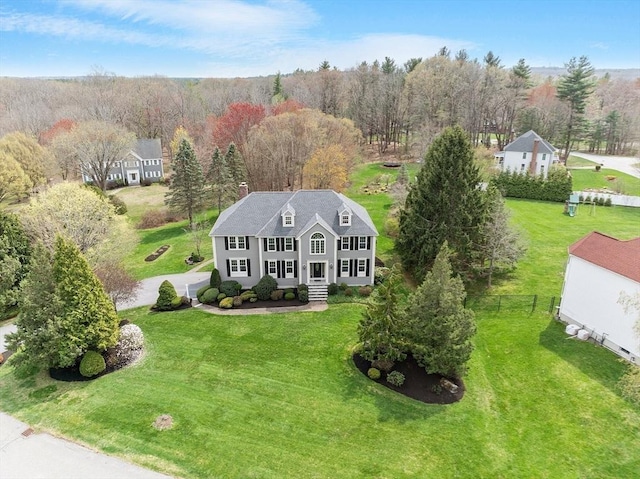 birds eye view of property with a view of trees
